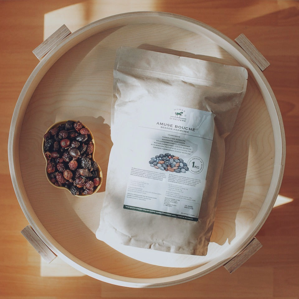 Overhead view of the 1 kg kraft paper bag and bowl of dried berries on a round wooden tray